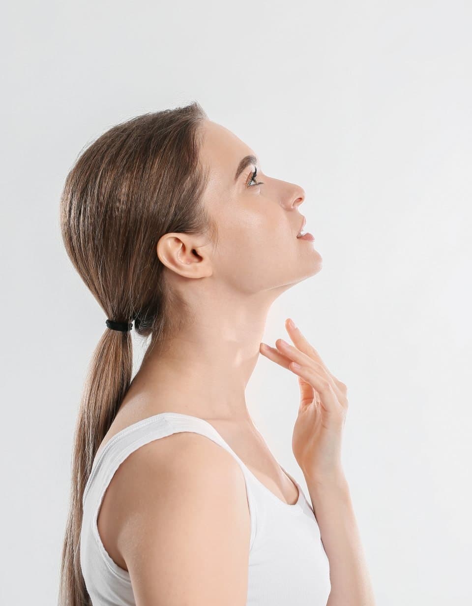 Woman with a sleek ponytail and glowing skin